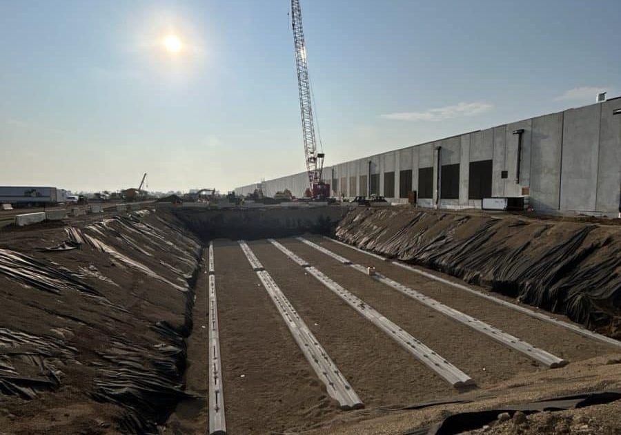 Prepared excavation with deadman anchors ready for fuel tank installation